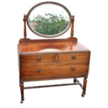 An early 20th century mahogany mirror back dressing table, the oval shaped mirror above two short