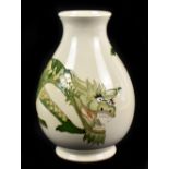 TREVOR CRITCHLOW FOR MOORCROFT; a baluster vase decorated in the 'Dragon' pattern on an ivory