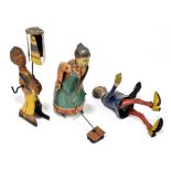 A German tinplate clockwork figure of Busy Lizzie, modelled with a floor brush, height 16cm, with