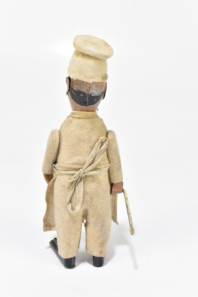 SCHUCO; a German tinplate clockwork model of a chef, with felt clothes and cotton apron, height 16. - Bild 4 aus 6