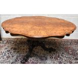 A Victorian walnut serpentine loo table, with quarter veneered top, on scroll legs, height 74cm,