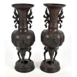 A pair of Japanese Meiji period bronze vases with moulded twin handles, height 43cm (2).