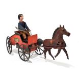 A vintage American tinplate clockwork toy modelled as a horse and cart with rider, the back of the