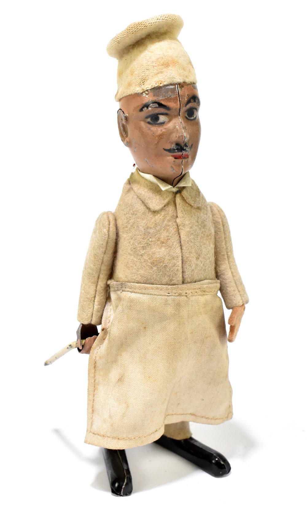 SCHUCO; a German tinplate clockwork model of a chef, with felt clothes and cotton apron, height 16.