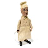 SCHUCO; a German tinplate clockwork model of a chef, with felt clothes and cotton apron, height 16.