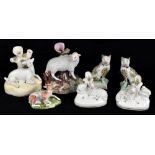 Seven 19th century ceramic figures of animals including four Staffordshire spill vases each modelled