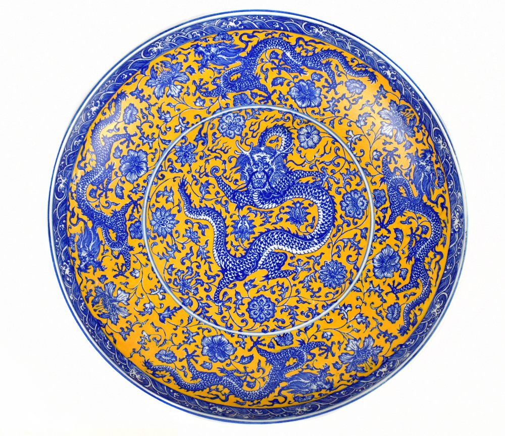 A modern Chinese circular bowl with transfer printed decoration representing a five clawed dragon