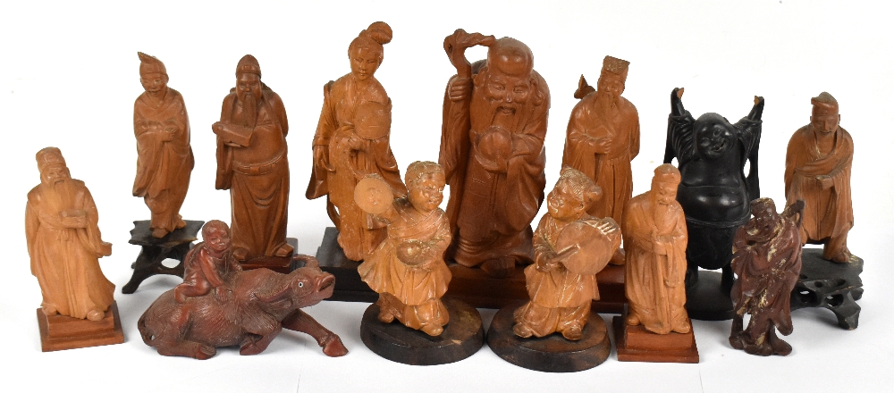 Ten Chinese carved camphor wood figures including the God of Longevity, height 19cm, together with