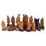 Ten Chinese carved camphor wood figures including the God of Longevity, height 19cm, together with