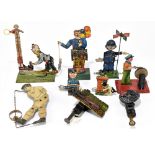 A collection of nine tinplate mechanical toys comprising a Gely mechanical 'Test your Strength' toy,