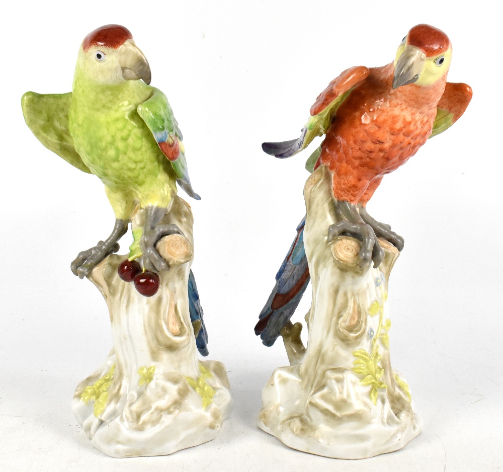 BIDASOA; a pair of Spanish porcelain figures of parrots perching on naturalistic plinth bases,