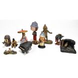 A collection of late 19th century and later diecast figures and vesta holders comprising a seated