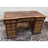 HOWARD AND SONS; a 19th century kneehole twin pedestal desk, with brown tooled leather inset top