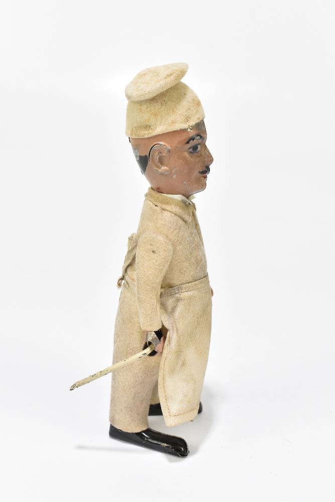 SCHUCO; a German tinplate clockwork model of a chef, with felt clothes and cotton apron, height 16. - Bild 3 aus 6