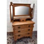 An early 20th century oak mirror back dressing table, the triple mirror back above one short and
