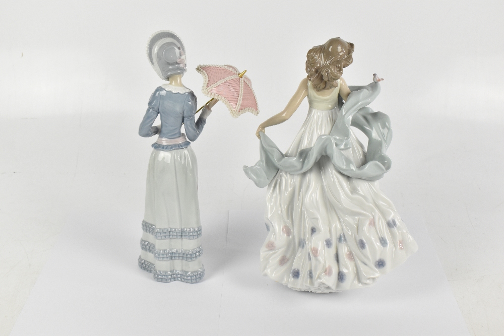 LLADRO; two figures comprising a maiden wearing a bonnet hat and holding a parasol, height 32cm, and - Image 2 of 4
