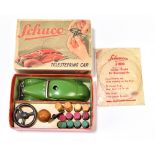 SCHUCO; a boxed tinplate clockwork telesteering car with ball pegs, ball, steering wheel, key and