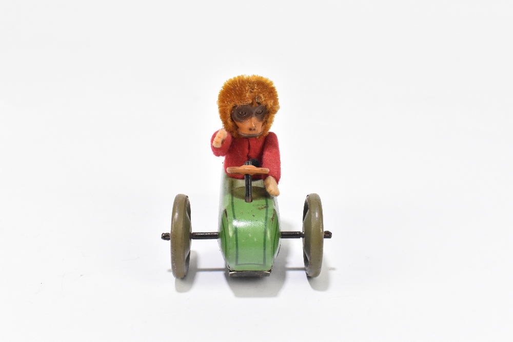 SCHUCO; a tinplate friction model of a three wheel motorcar with monkey driver, length 9cm. - Bild 4 aus 5