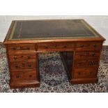 An early 19th century mahogany partners' desk of small proportions with tooled leather inset top