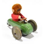 SCHUCO; a tinplate friction model of a three wheel motorcar with monkey driver, length 9cm.