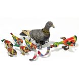 A German tinplate clockwork pigeon toy with articulated head, five Fairylite clockwork birds, and