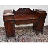 A Regency mahogany twin pedestal sideboard, with carved gallery back to the centre above two