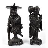 A Chinese carved rootwood figure of a male wearing a flat hat and holding beads, height 40cm,