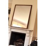 A large over mantle mirror with a wooden frame. 130 x 98cm