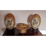 A pair of large Satsuma decorated ceramic eggs on wooden bases, H40cm inc bases, along with a