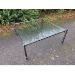 A substantial contemporary glass coffee table on a metal base. Heavy item. 100cm x 100cm glass.