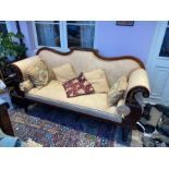 Regency sofa carved with Rococo style scrolled arms, back and adornments