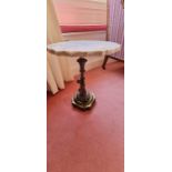Small wine table with a marble top, a cast leg depicting a classical cherub on a brass base (