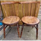 Pair of vintage spindle back farmhouse chairs with turned legs.