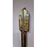 Wall mounted stick barometer with brass face.
