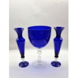 A large oversize glue glass wine glass with a pair of matching vases. (3)