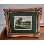 Decorative oil painting of a lake in a gilt frame. 30 x 25cm
