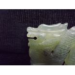 Chinese Jade Hardstone carving of a Dragon. Black inclusion in pale stone. 7cm at longest point.