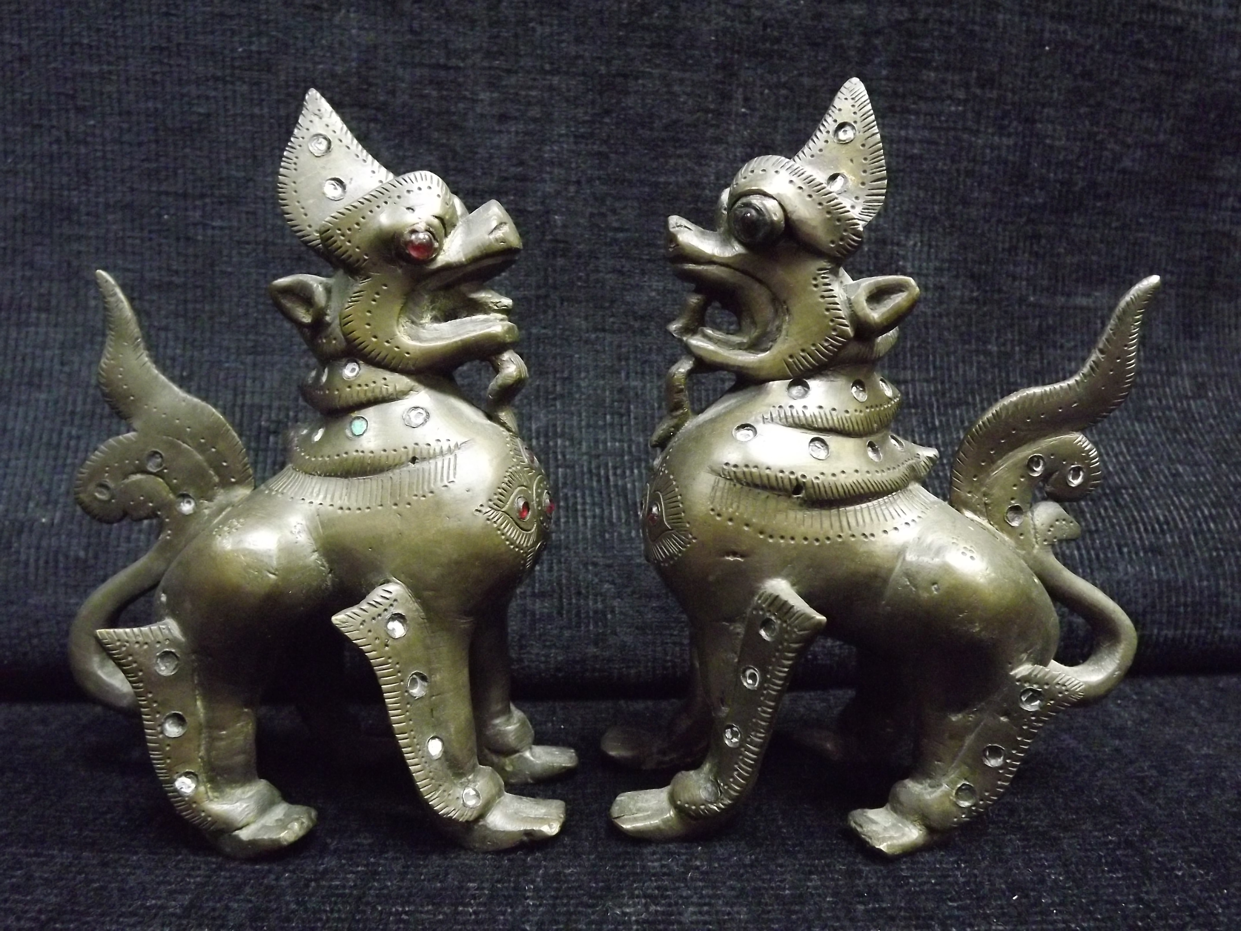 Pair of Chinese / Sino Tibetan - Gilt Bronze Mythical Beast. Glass or Stone Eyes and decoration.