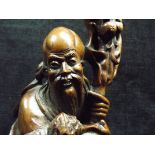 Chinese Hardwood Carving of Shou Lao. Carrying his gnarled staff with gourd bottle and a branch of