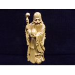 Chinese Boxwood Carving of Shou Lao in typical pose. The God of longevity with his staff and