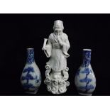 Chinese Blanc De Chine / Dehua figure of Fu with a pair of Miniature Blue and White Vases. The