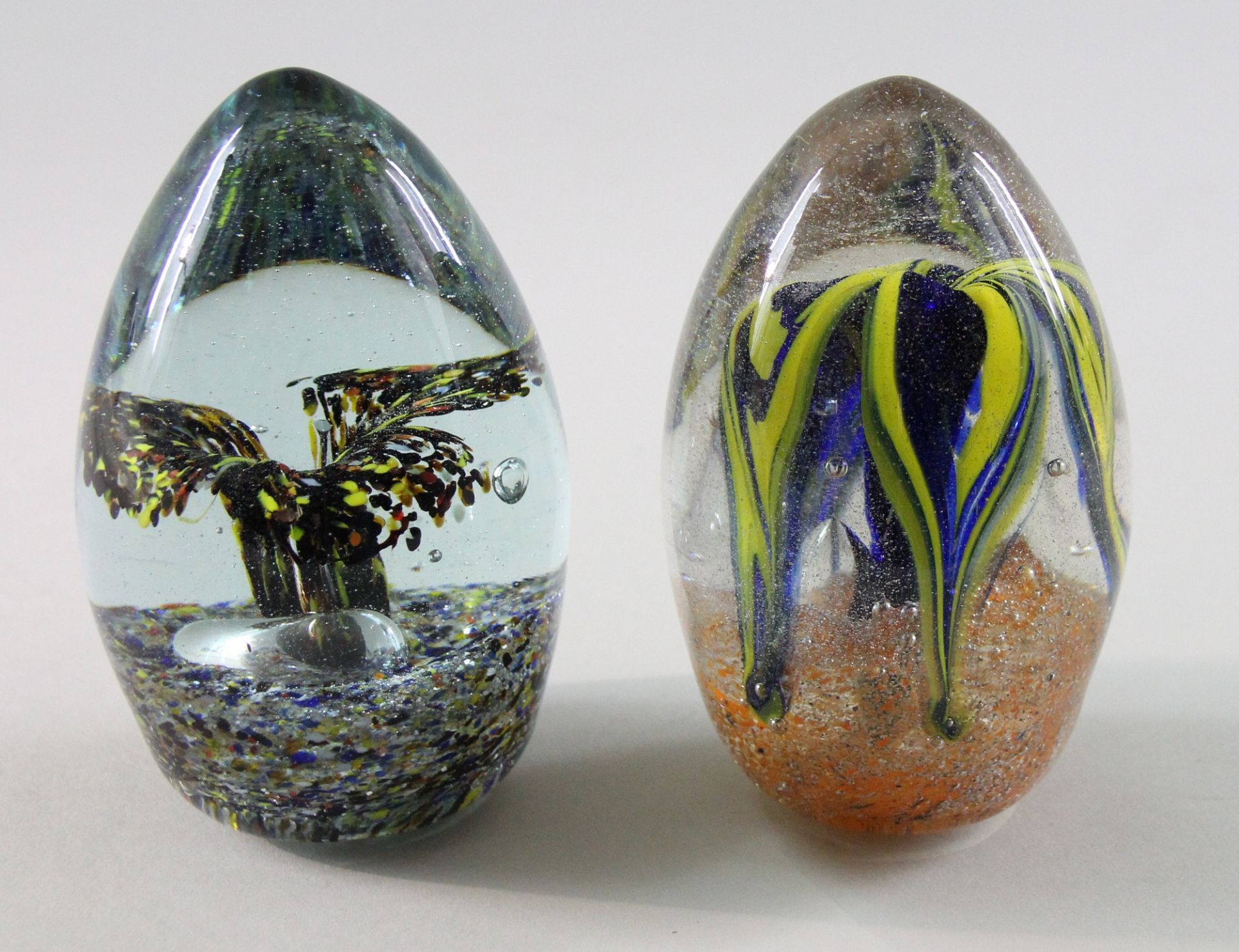 2 Paperweights, "Blüten", 20. Jhd. Aufrechtstehende Zapfenform, Klarglas, im Zentrum Blüten in Gelb