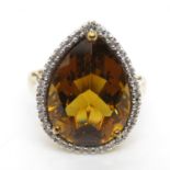 9ct gold with large amber stone and diamond chipping halo ring size M 4.7g