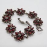 Silver flower design bracelet with red stones 23.7g