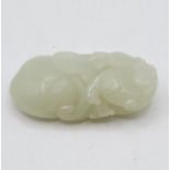 Carved jade leopard on top of peach 2.5" long x 1.5" wide