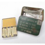 Tin box marked Delay Capsules No 3 containing tin opener and wire cutters and tin containing anti-