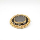 18ct front and 9ct back Memorium brooch with woven hair and black enamel with original leather