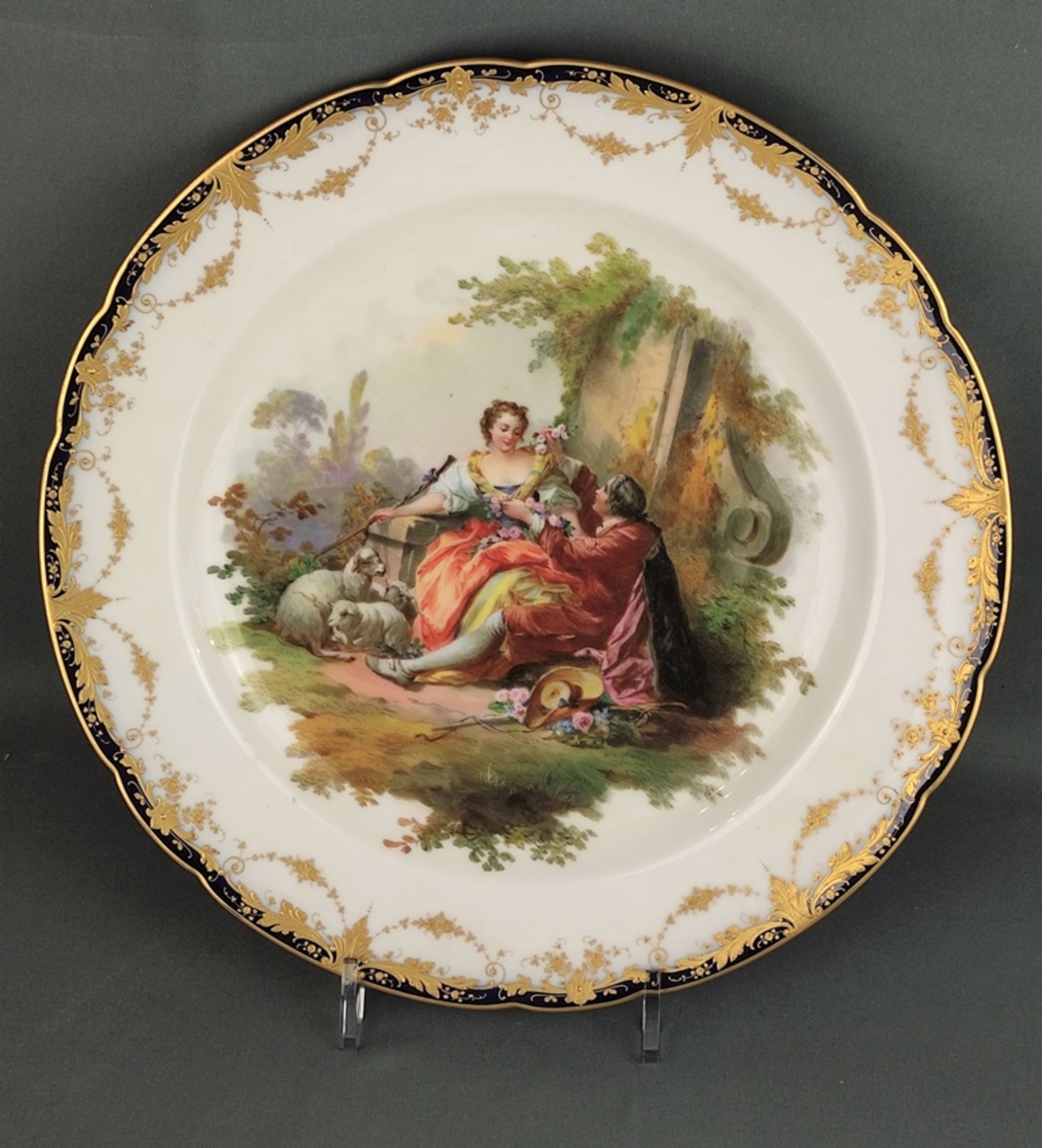 Large plate, centered fine polychrome painting with shepherd scene, couple sitting, each with sheph