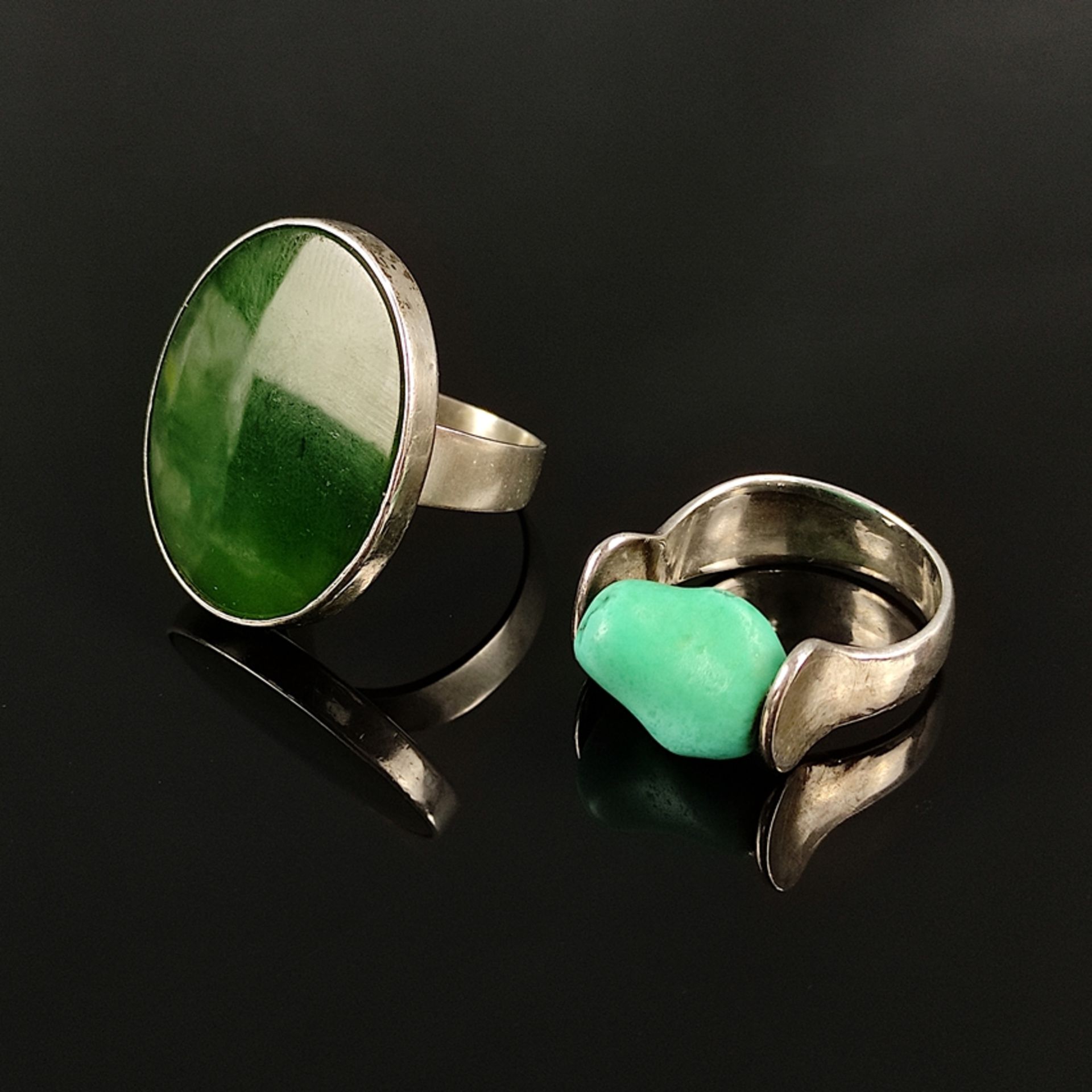 Two modern rings, one with a large oval dark green stone, dimensions 28,4x23,5mm, silver 925, 12,4g