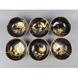Six black lacquer bowls, finely painted with gold with various plants, height 5cm and diameter 12cm